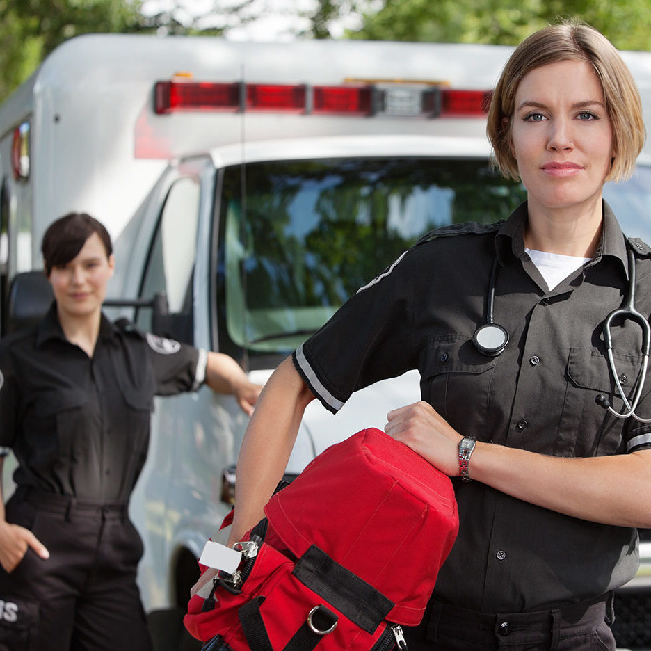 EMS professional with portable oxygen equipment