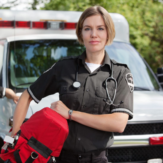 EMS professional with portable oxygen equipment