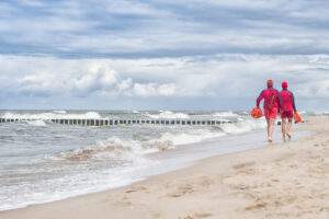 Lifeguards walking along beach