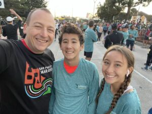 Steven Lome, D.O., is pictured with his two teenage children. Dr. Lome saved two people who each experienced cardiac arrest during the Monterey Bay Half-Marathon in late 2021.