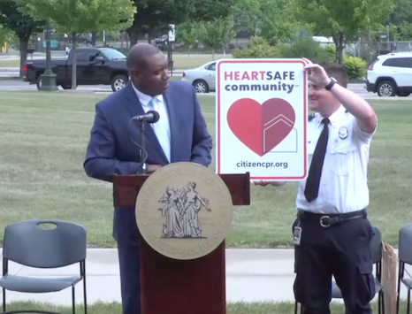 Detroit Commissioner Chuck Simms (left) joins Detroit Fire Captain Jeff Forbes in celebrating Detroit's designation as a HEARTSafe Community during an August 27th ceremony.